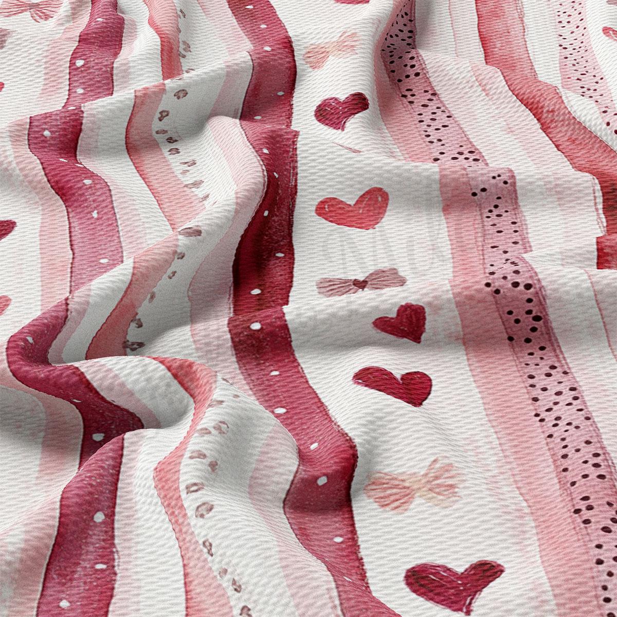 The image is a close-up view of a fabric with a repeating pattern of pink and white stripes, along with small red hearts and pink bows.