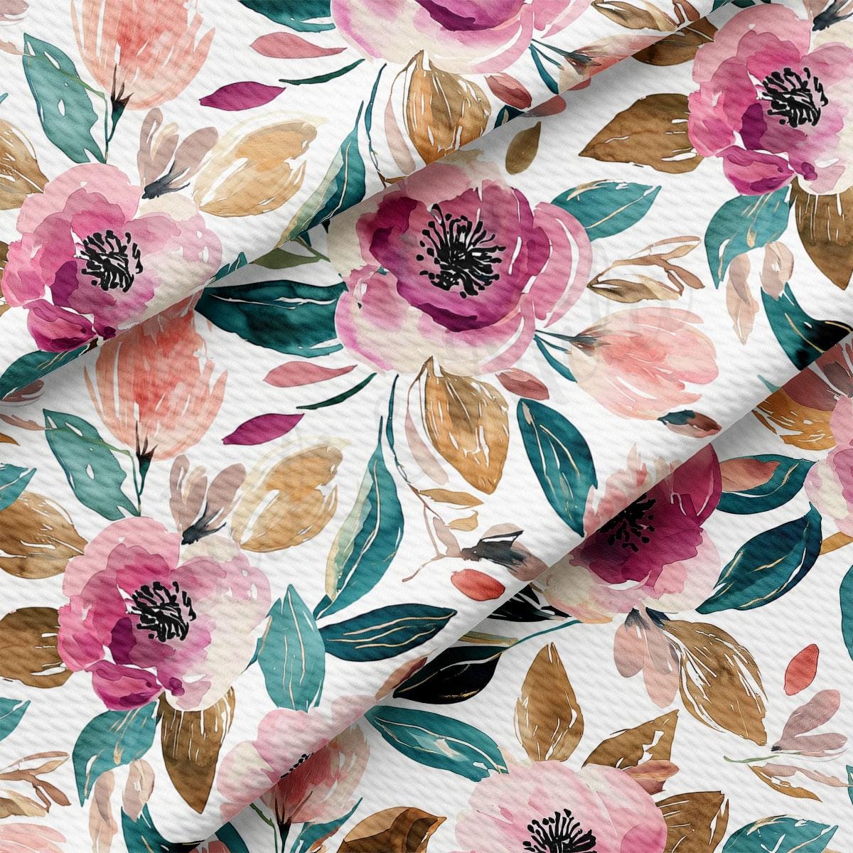 a close-up view of a fabric with a floral pattern. The pattern consists of various pink and green flowers, leaves, and other natural elements. The fabric appears to be folded or rolled, creating a visually appealing and textured design.