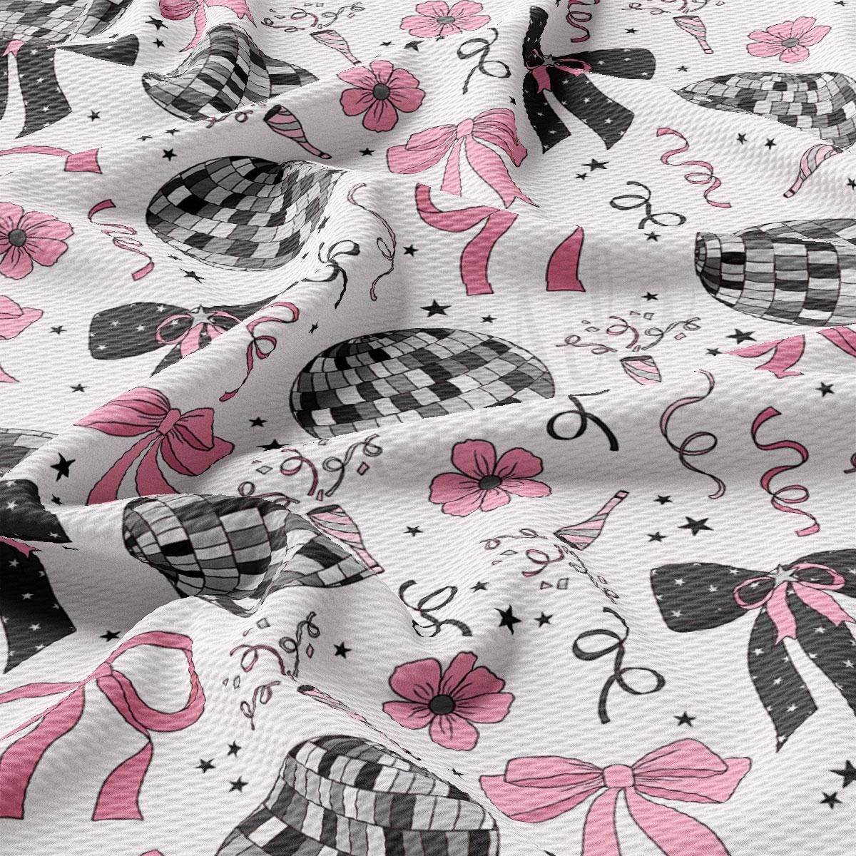 a close up of a white fabric with pink and black designs