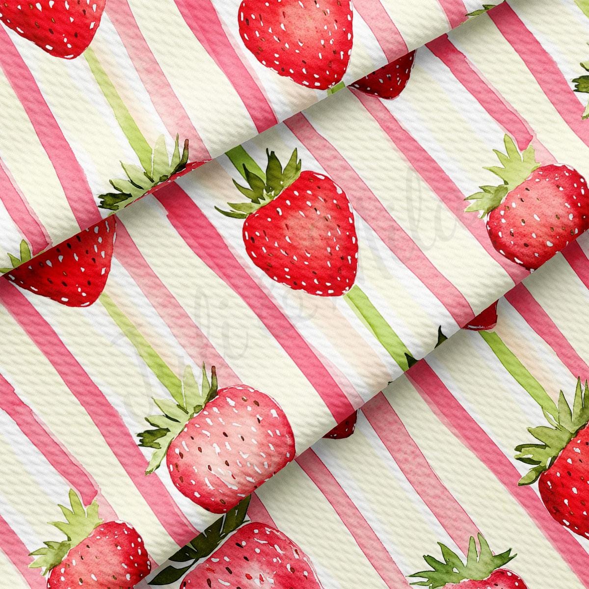 a red and white striped fabric with strawberries on it
