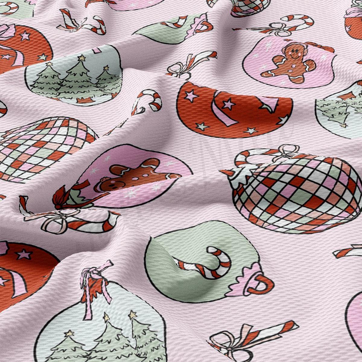 a close up of a pink fabric with christmas ornaments on it