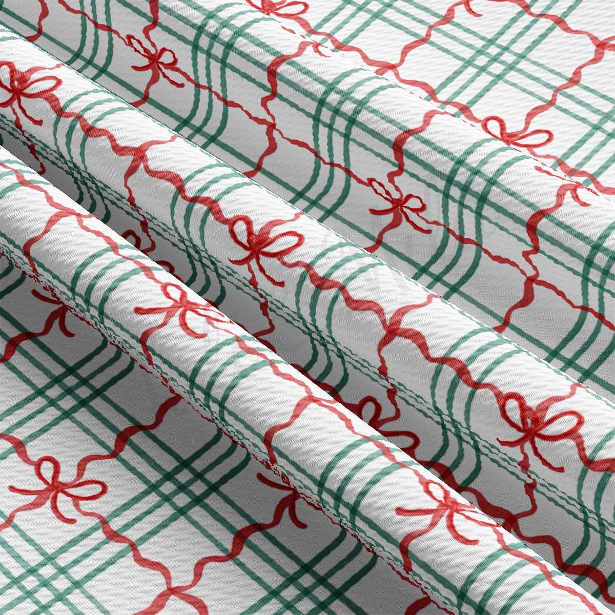 a close-up view of a fabric with a repeating pattern of green and red checkered lines and red bows.