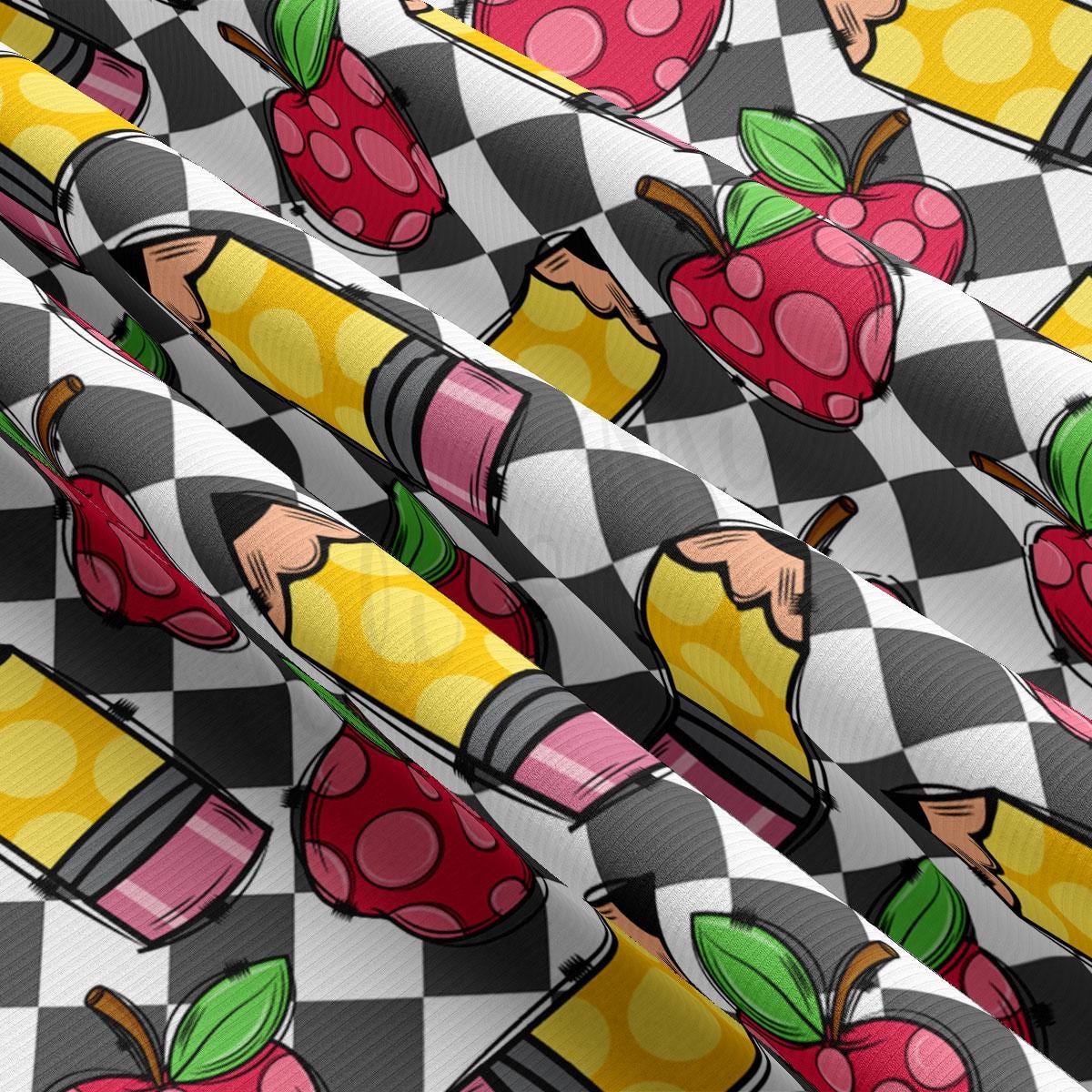a close up of a pattern with apples and pencils
