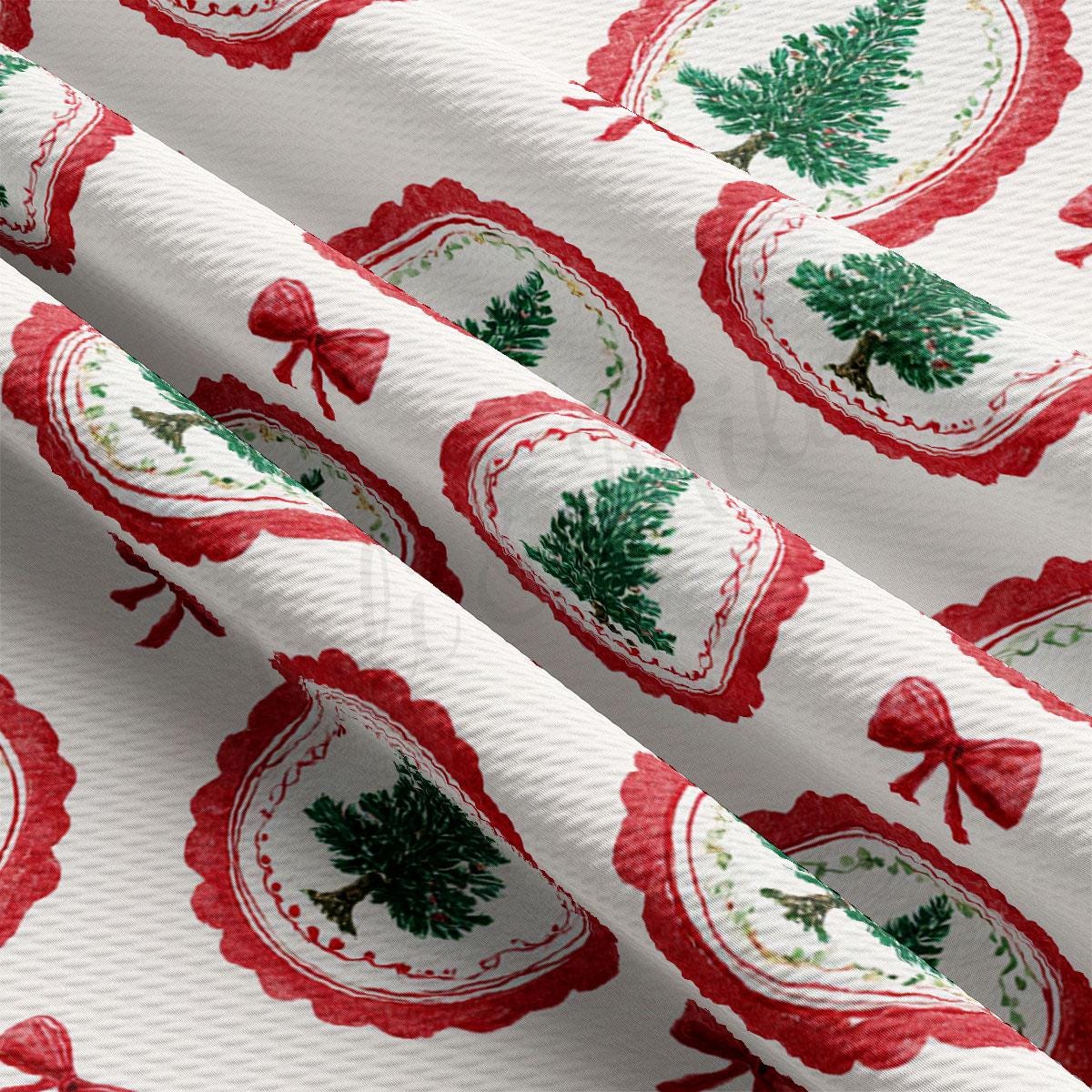 a close-up view of a fabric with a repeating pattern of red and white Christmas tree designs. The pattern includes various shapes and sizes of Christmas trees, as well as red bows, creating a festive and holiday-themed design.