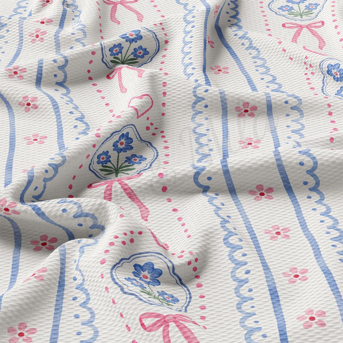 a close-up view of a fabric with a floral pattern, featuring blue and pink flowers and decorative elements.