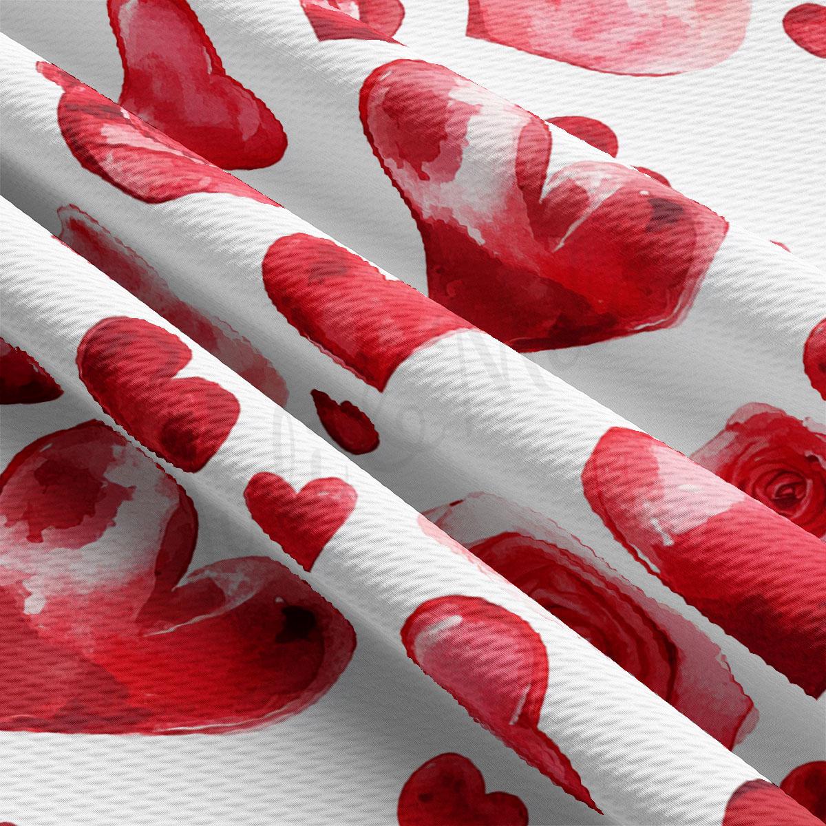 a close-up view of a fabric with a repeating pattern of red hearts on a white background.