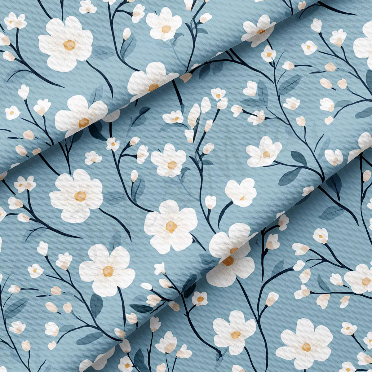 a repeating pattern of white flowers with green leaves against a light blue background.