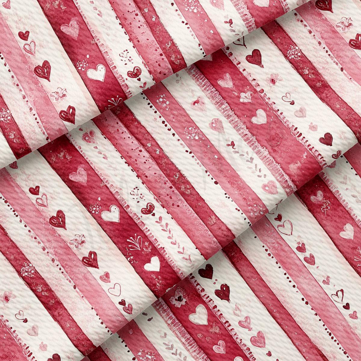 a close-up view of a fabric with a repeating pattern of red and white stripes, along with various heart shapes in shades of pink and white. The pattern is arranged in a diagonal direction, creating a visually striking and textured appearance.