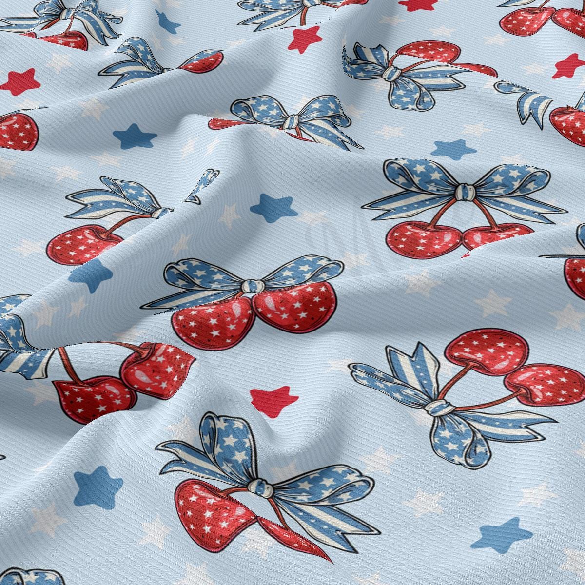 a blue fabric with red, white and blue cherries on it