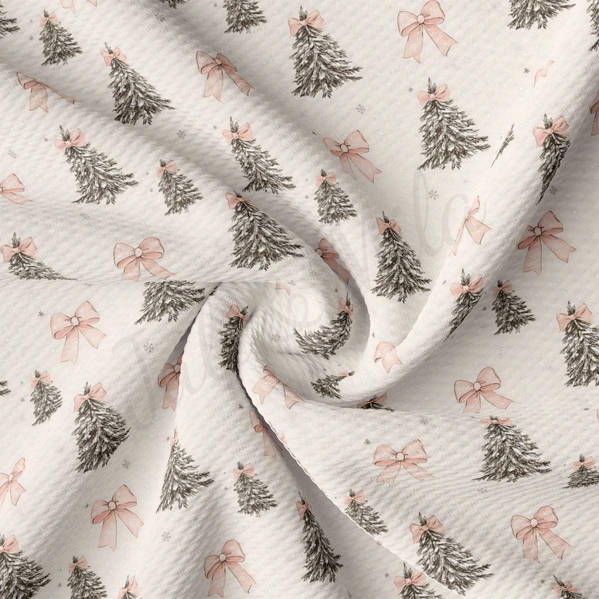a close-up view of a fabric with a repeating pattern of Christmas trees and pink bows.