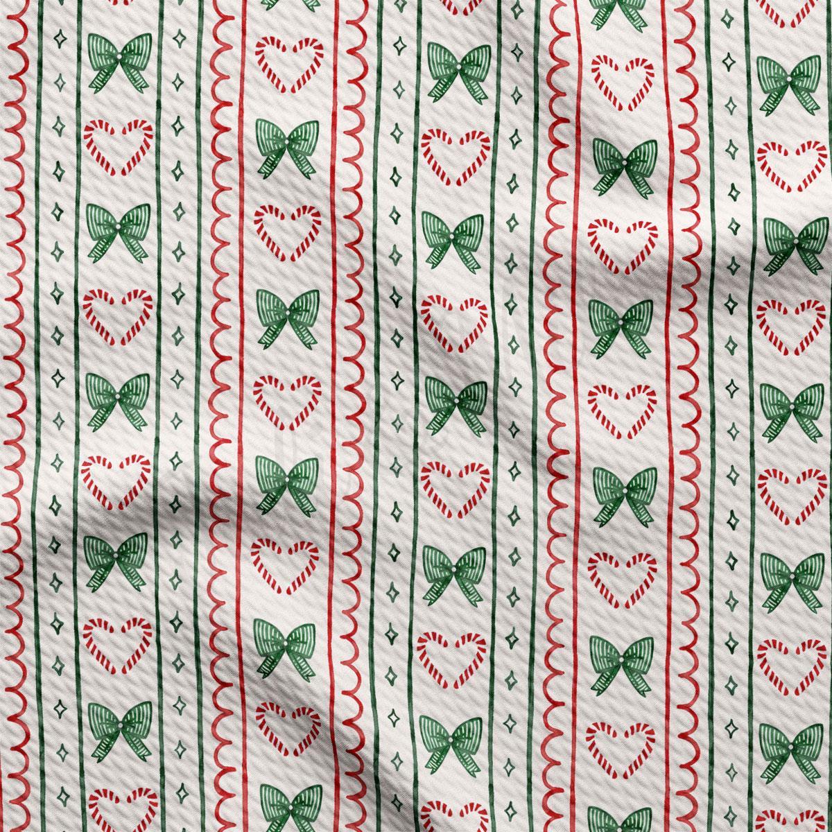 a repeating pattern of green and red bows, hearts, and candy canes on a white background.