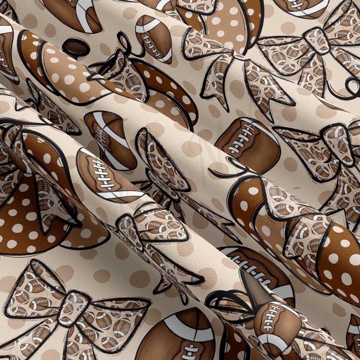 The image is a close-up view of a fabric with a repeating pattern of footballs and bows in shades of brown and white.