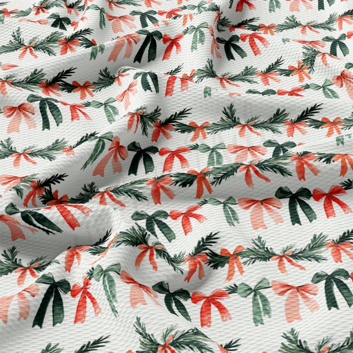 a close-up view of a fabric with a repeating pattern of green and red bows and pine branches.