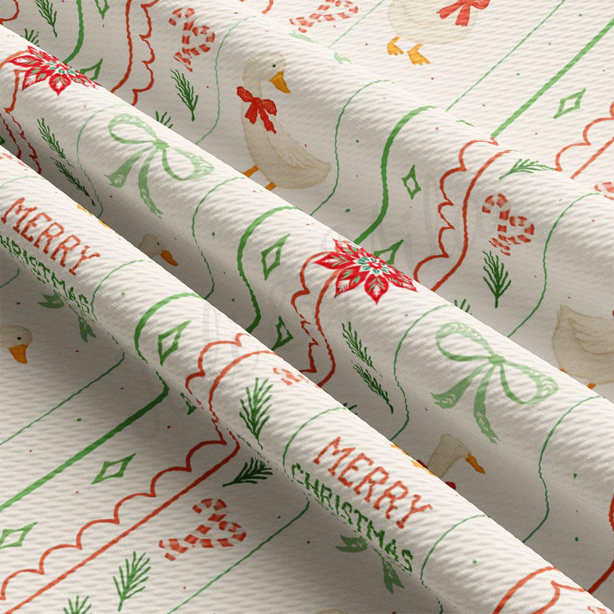 a close-up view of a fabric with a festive Christmas pattern. The fabric has a white background with green and red accents, including images of ducks, snowflakes, and Christmas trees. The text "MERRY CHRISTMAS" is visible, suggesting the fabric is designed for use as a gift or holiday-themed item.