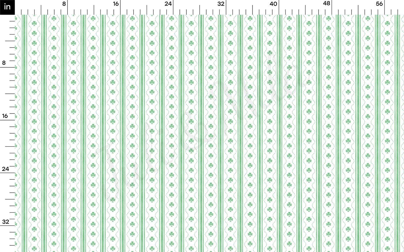 a green and white ruler with four leaf designs