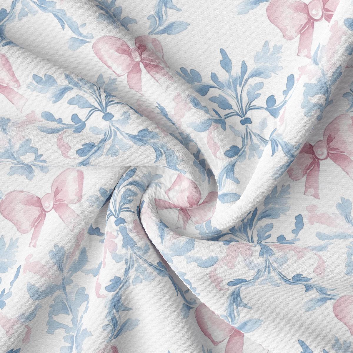 a close-up view of a fabric with a floral pattern in shades of blue and pink. The fabric appears to be wrinkled, giving it a textured and soft appearance.