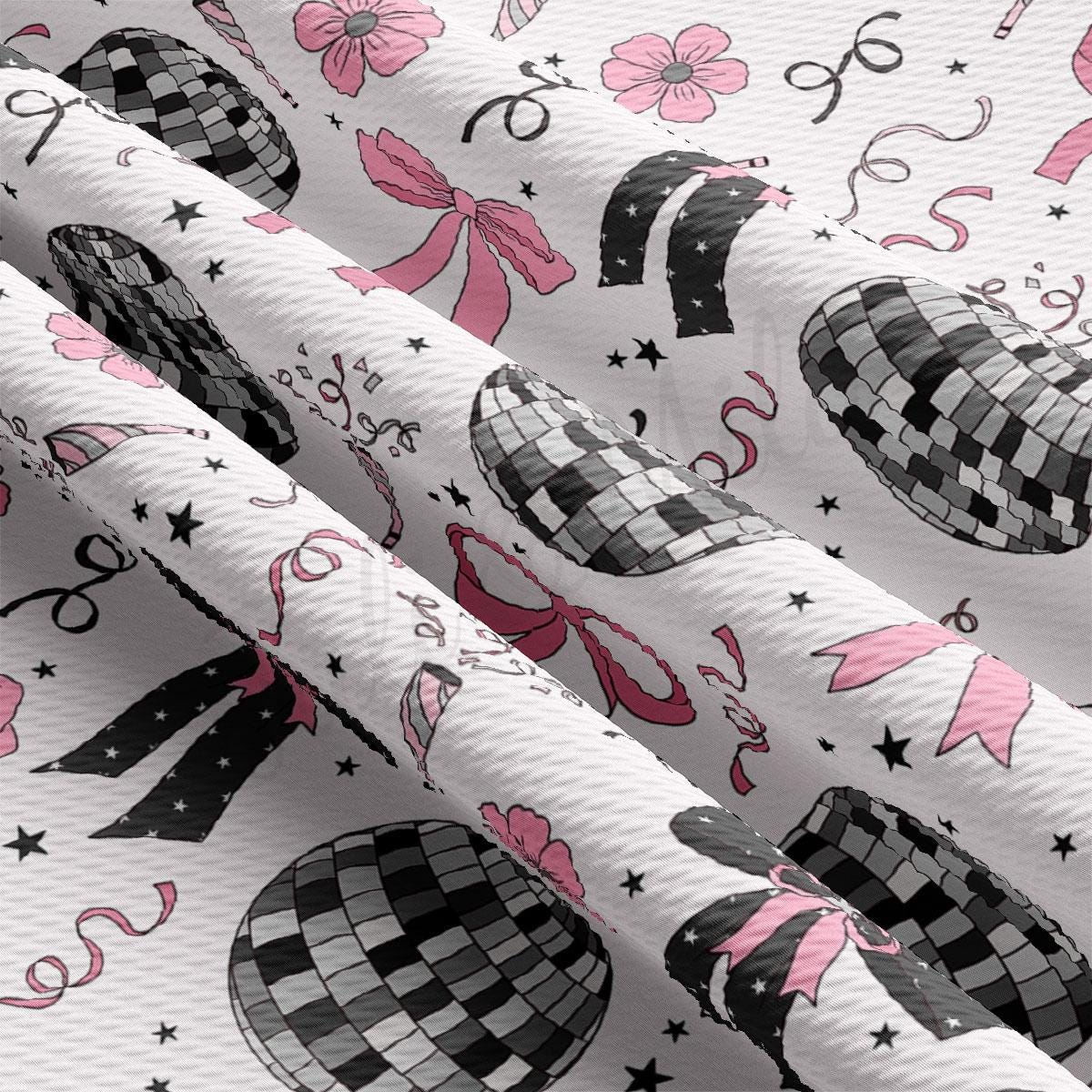 a close up of a white fabric with black and pink designs