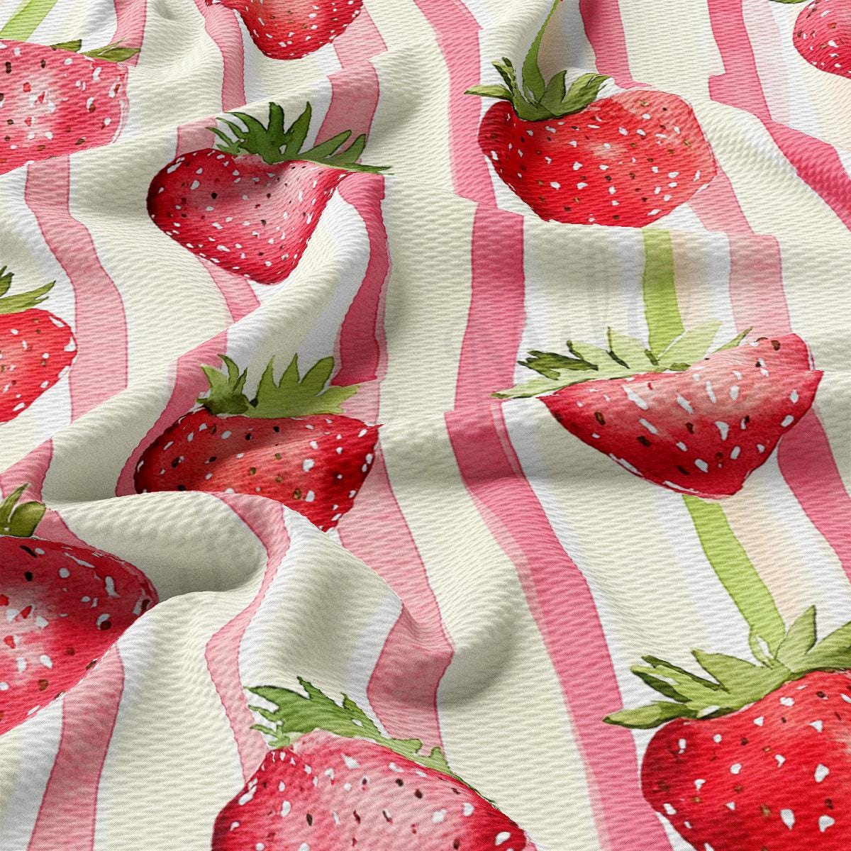 a pink and white striped fabric with strawberries on it