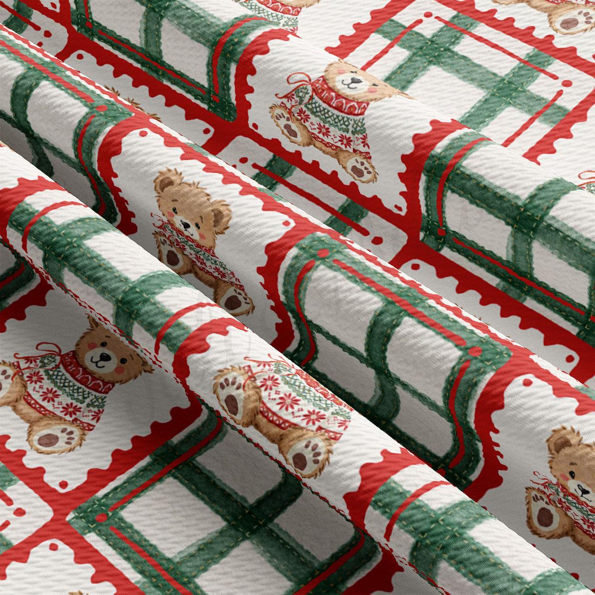 a close-up view of a fabric with a repeating pattern of teddy bears wearing sweaters in red and green colors.