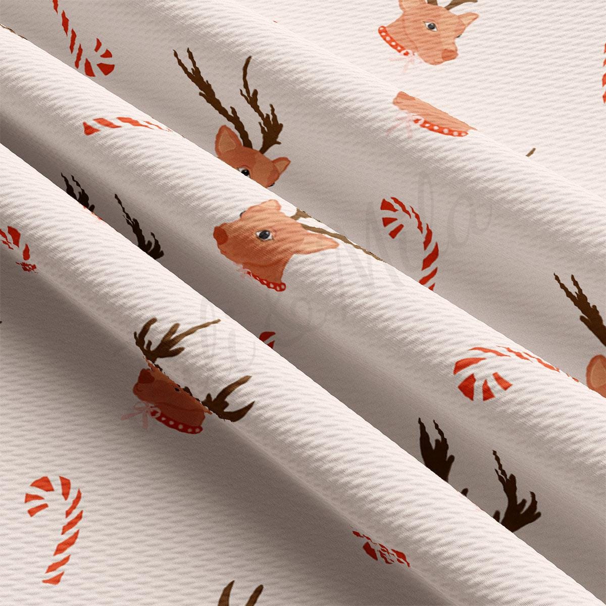 a white wrapping paper with reindeers and candy canes on it