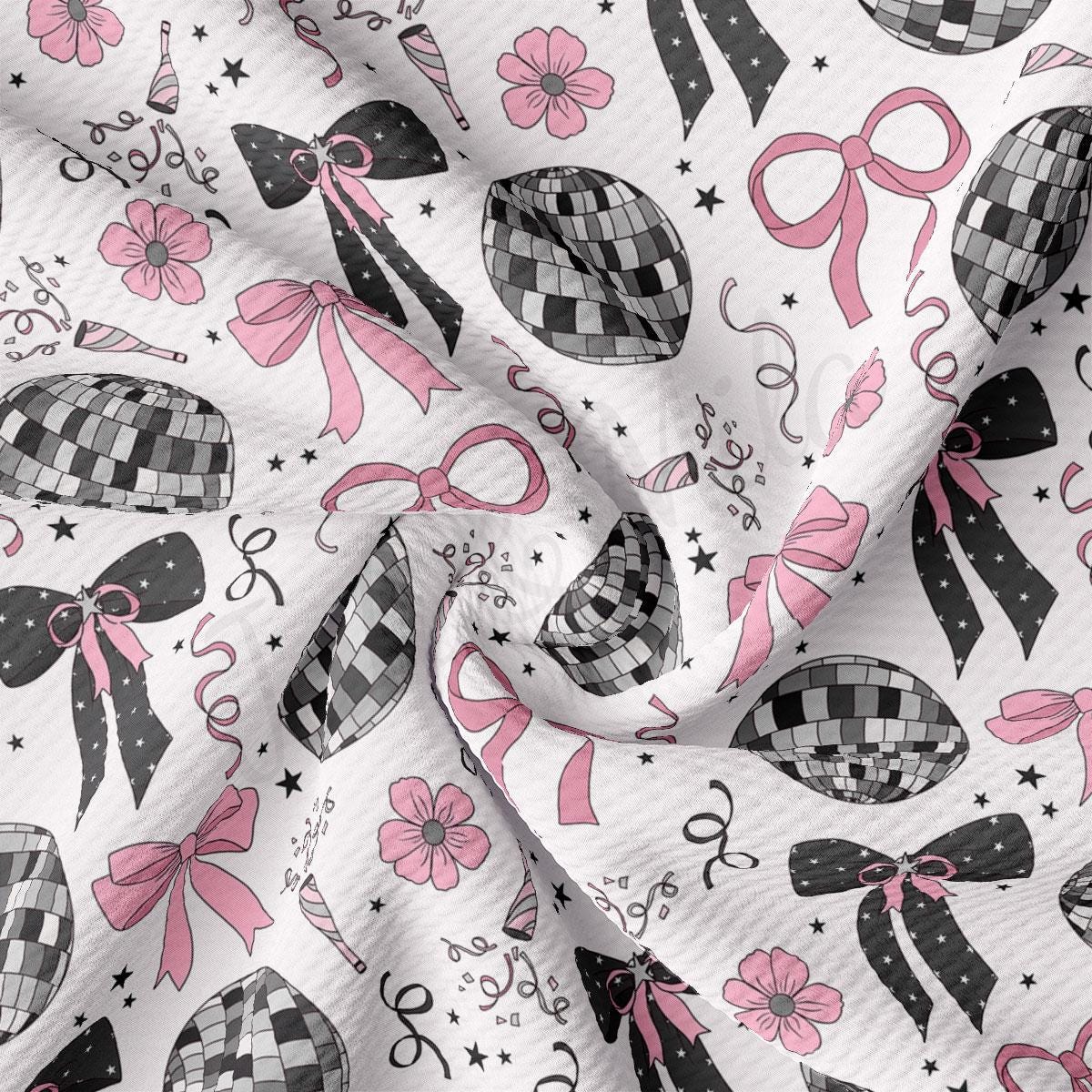 a white fabric with pink bows and bows on it