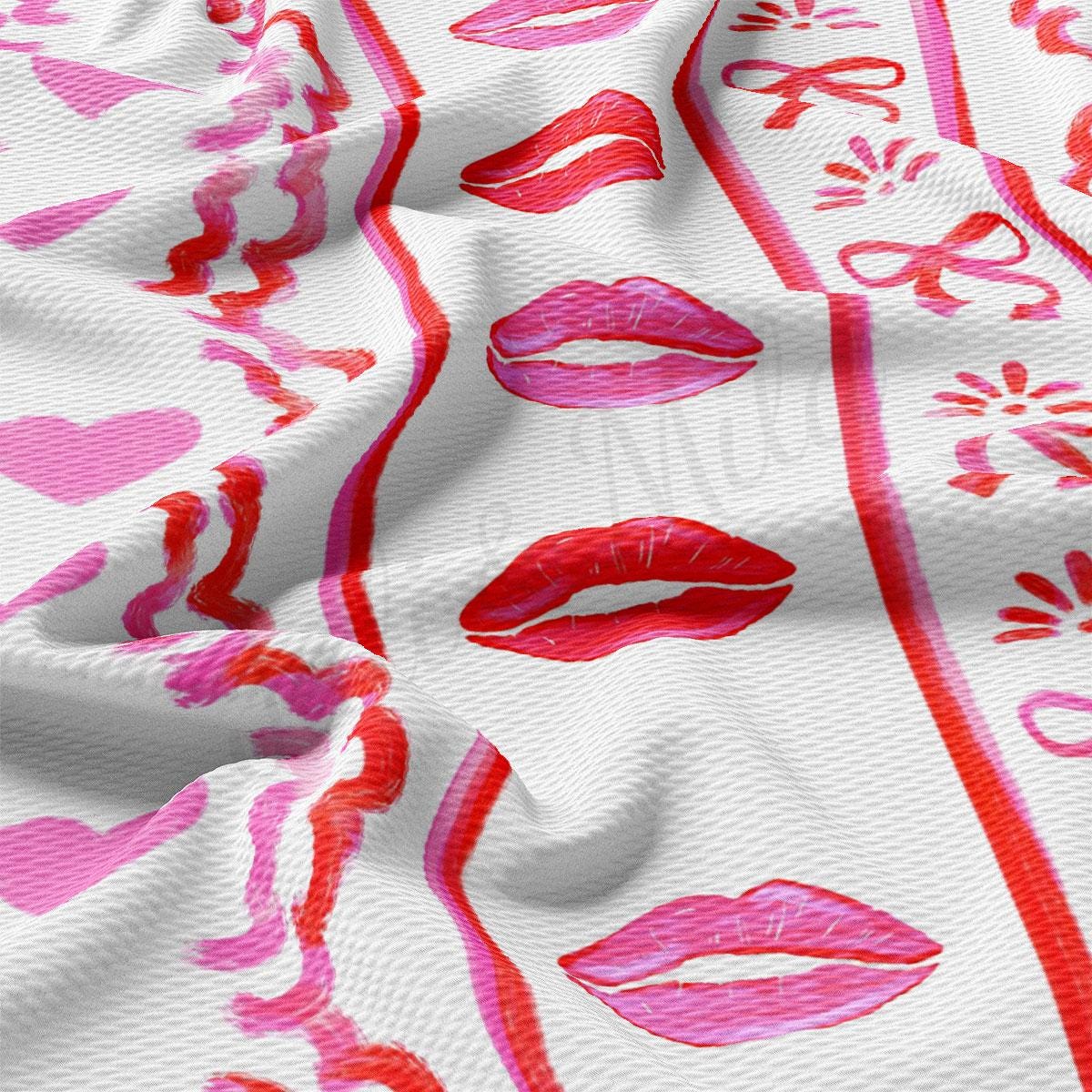 a close up of a pink and white fabric with lipstick prints
