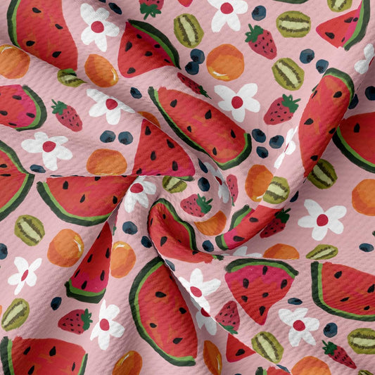 a pink fabric with watermelon and berries on it