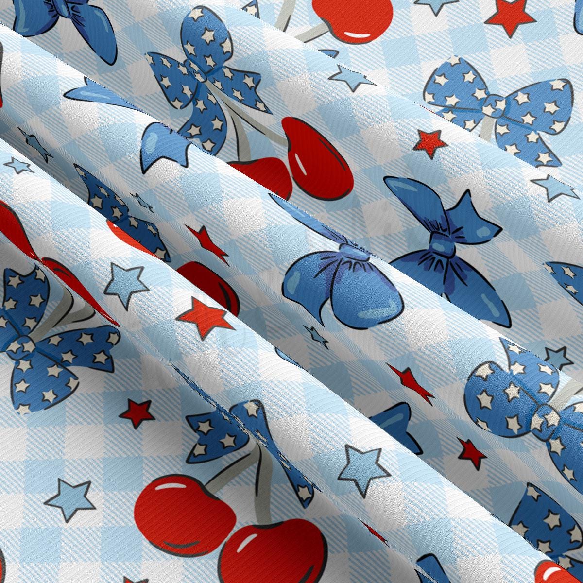 a blue and white checkered fabric with red, white, and blue cherries