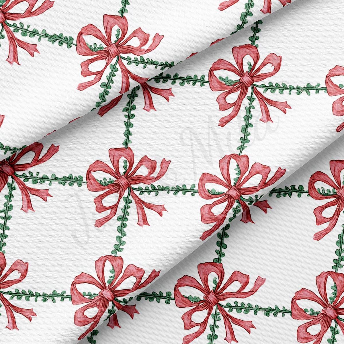 a repeating pattern of red bows with green leaves on a white background.