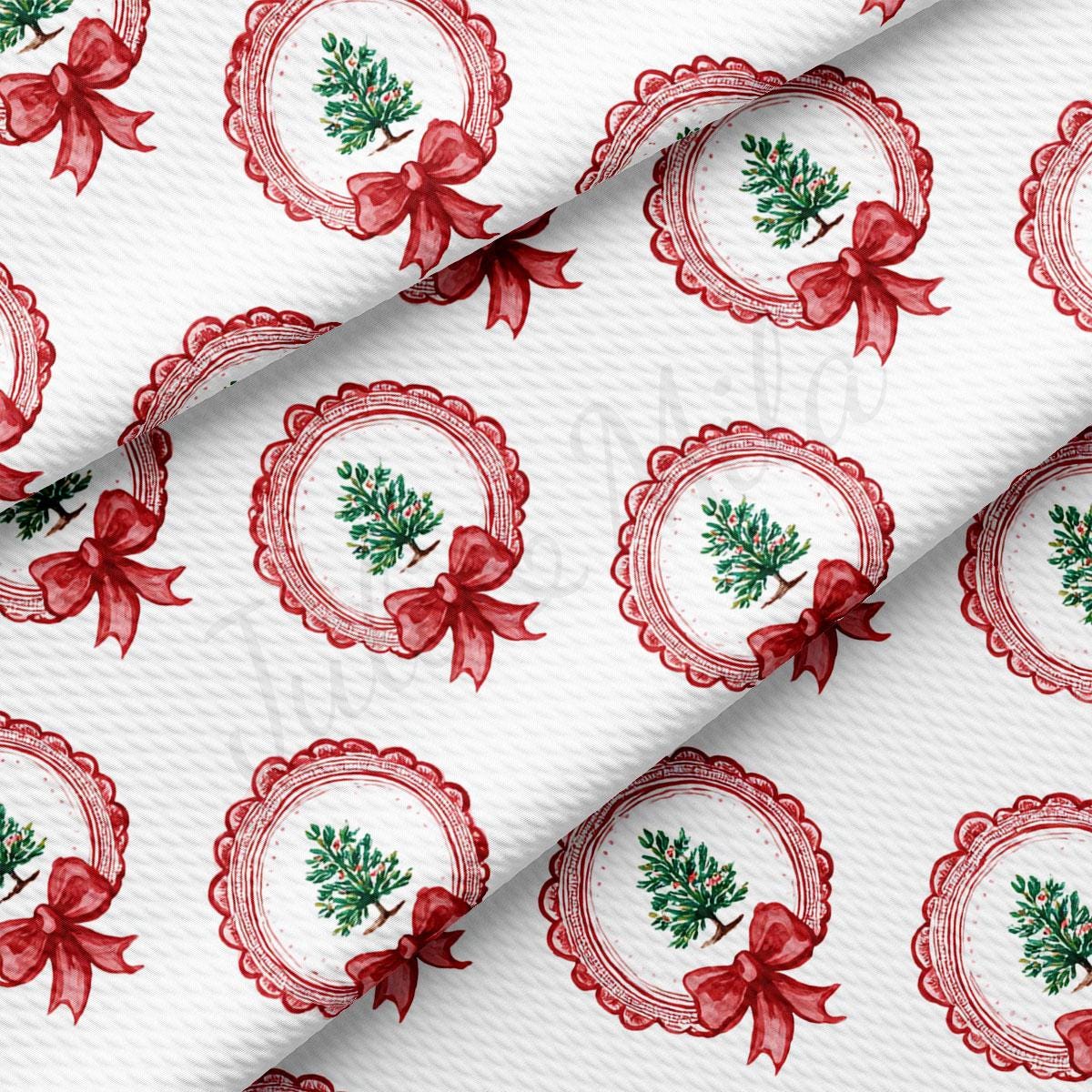 a repeating pattern of red bows and Christmas trees on a white background.