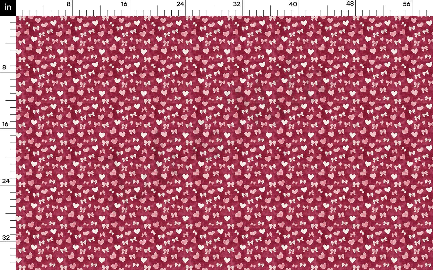 The image is a fabric with a repeating pattern of red hearts and white bows. The pattern is composed of small white hearts and bows arranged in a grid-like fashion, creating a visually appealing and intricate design.
