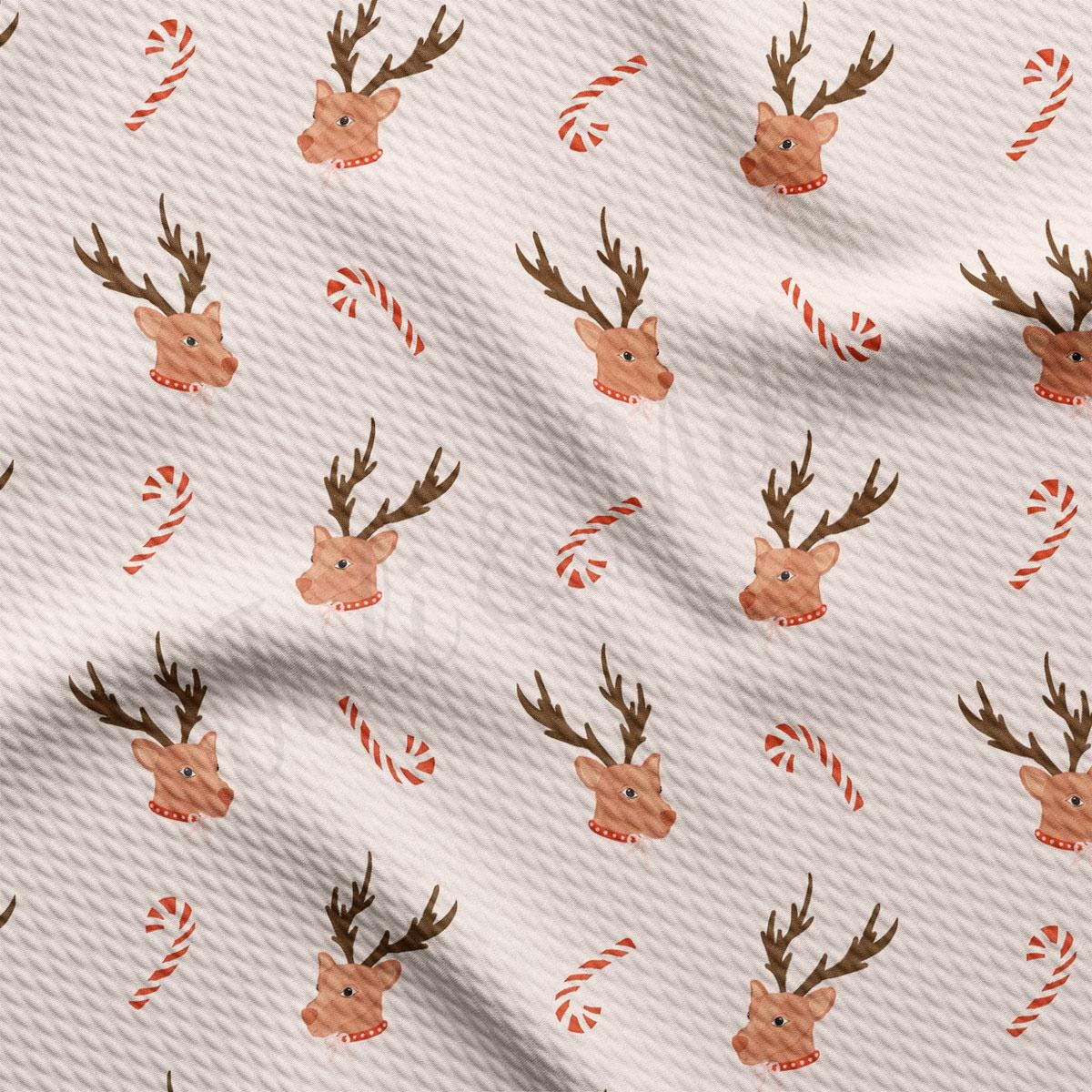 a white fabric with reindeer heads and candy canes on it