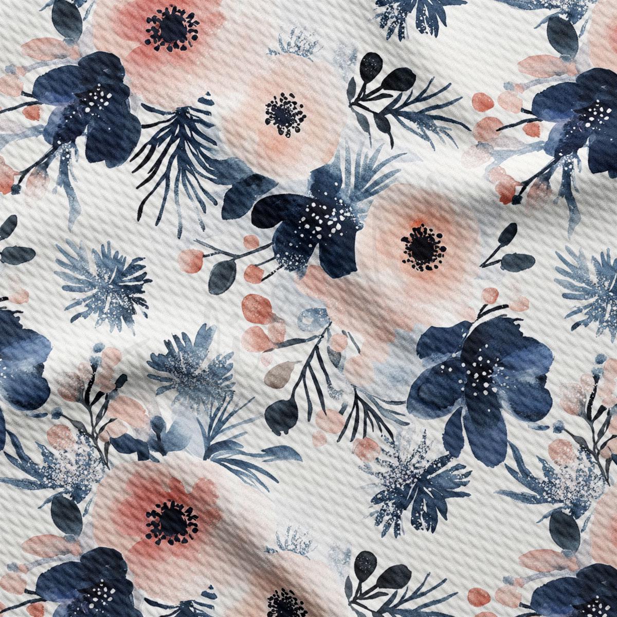a close-up view of a fabric with a floral pattern. The pattern consists of various flowers and leaves in shades of blue, pink, and white, creating a visually appealing and textured design.