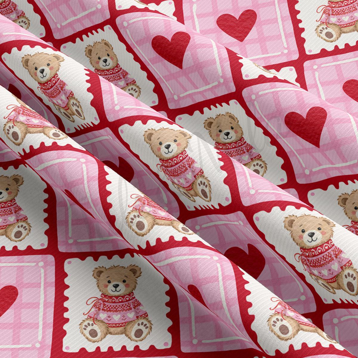 a fabric with a repeating pattern of pink and white squares, each containing a teddy bear wearing a red sweater and a heart.
