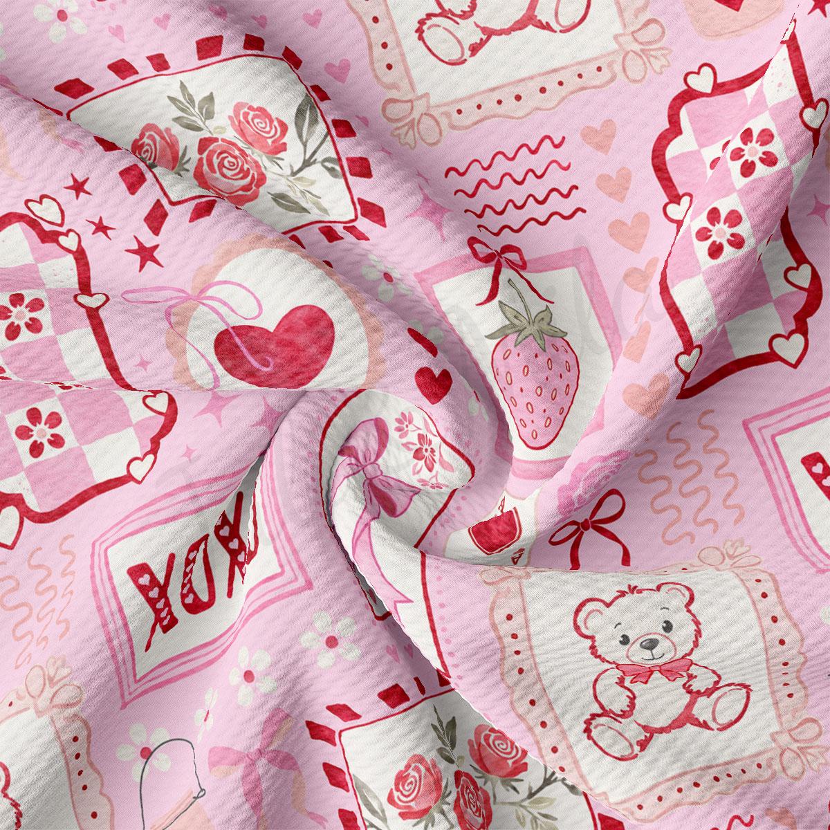 The image is a close-up of a fabric with a pink and white color scheme, featuring various decorative elements such as hearts, flowers, and a teddy bear.