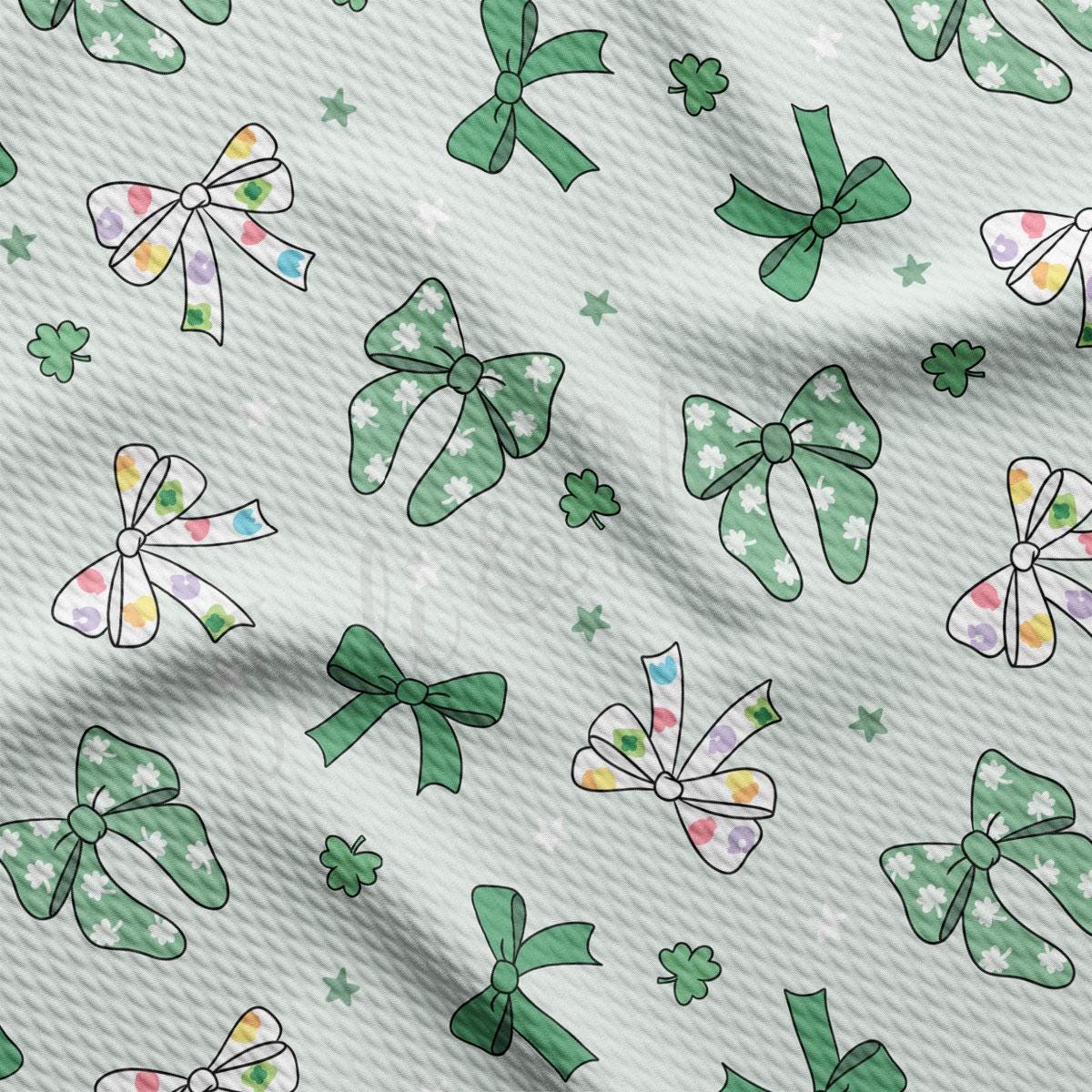 a green and white pattern of bows and stars