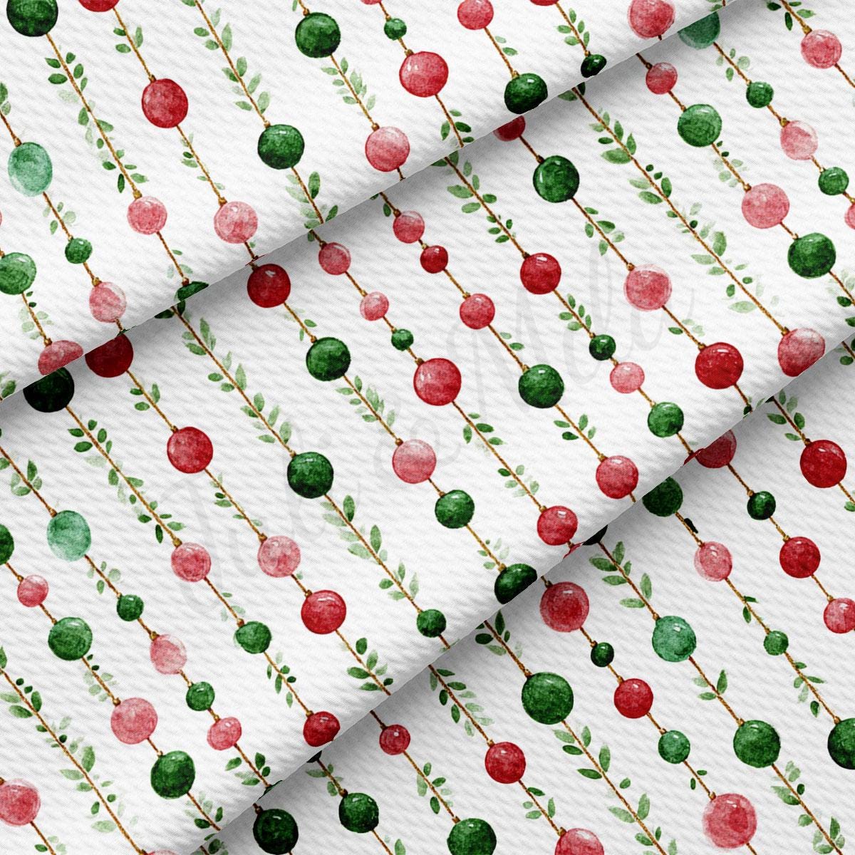 a repeating pattern of red and green spheres on a white background, with green leaves and brown stems.