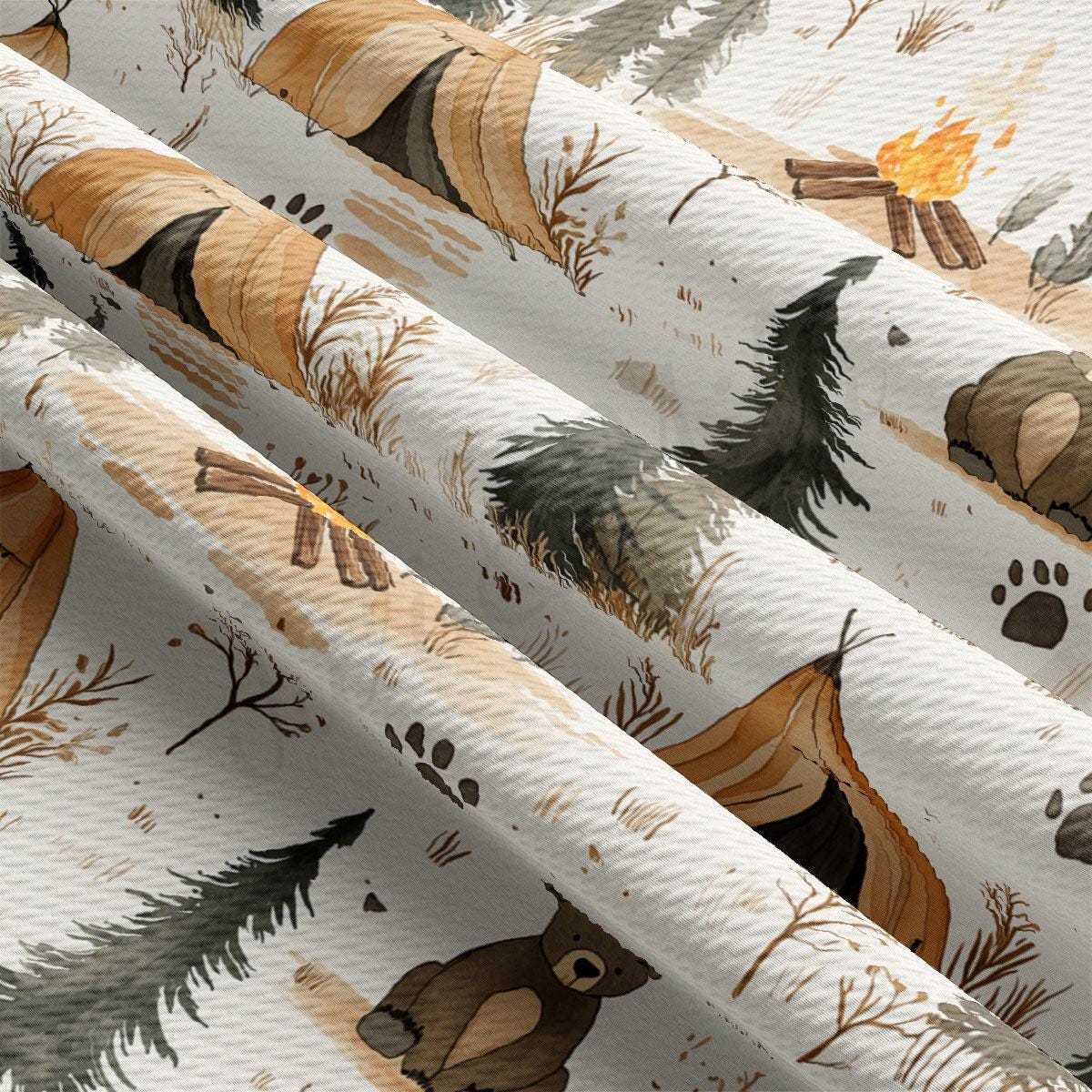 The image is a close-up of a fabric with a repeating pattern of camping-related elements, including tents, campfires, and trees.