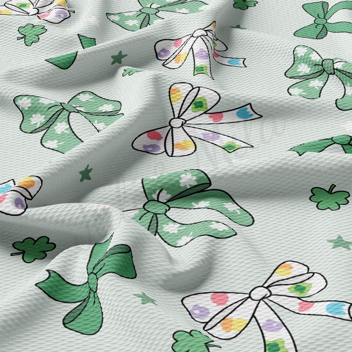 a close up of a white fabric with shamrocks on it