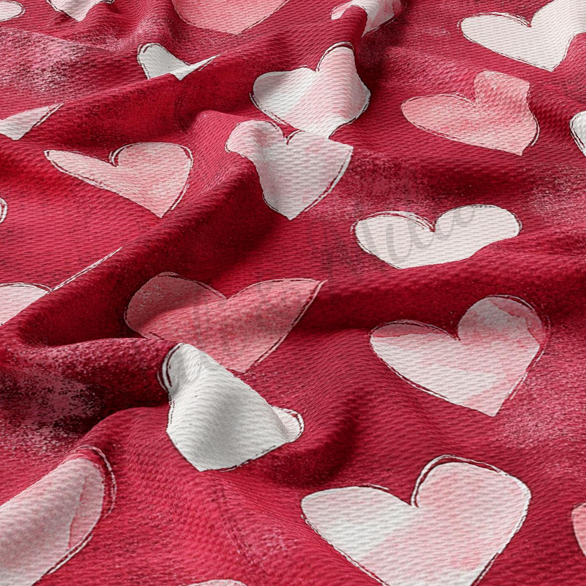 a close-up view of a red fabric with white heart shapes scattered across it.