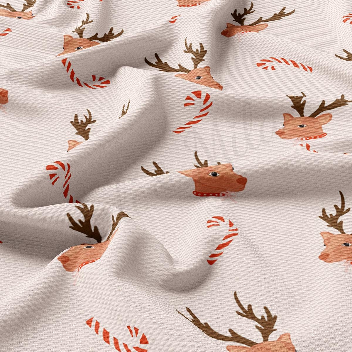 a white fabric with reindeers and candy canes on it