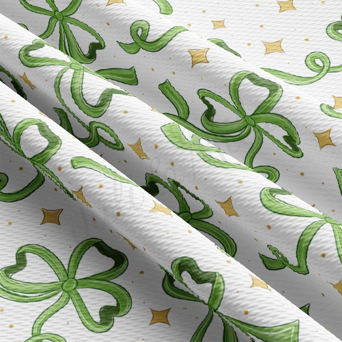 a close up of a green and gold pattern on a white background