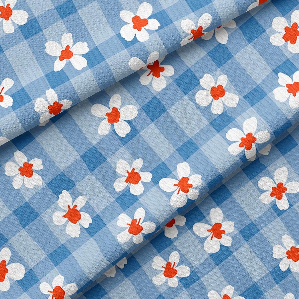 a blue and white checkered fabric with red and white flowers
