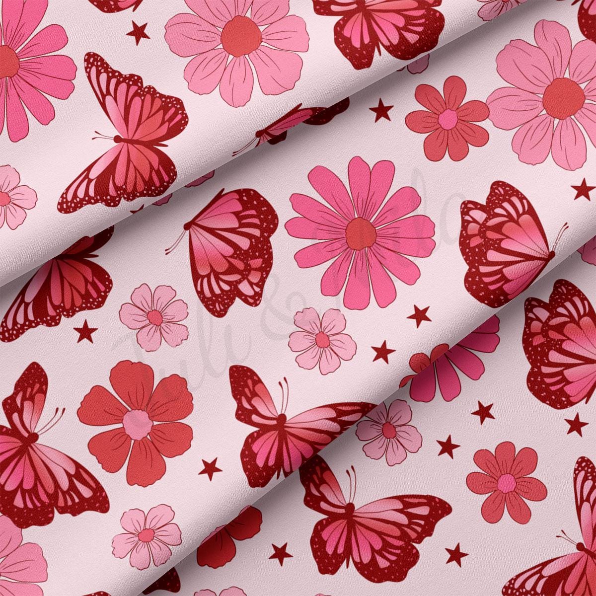 a pink and red flower and butterfly print fabric