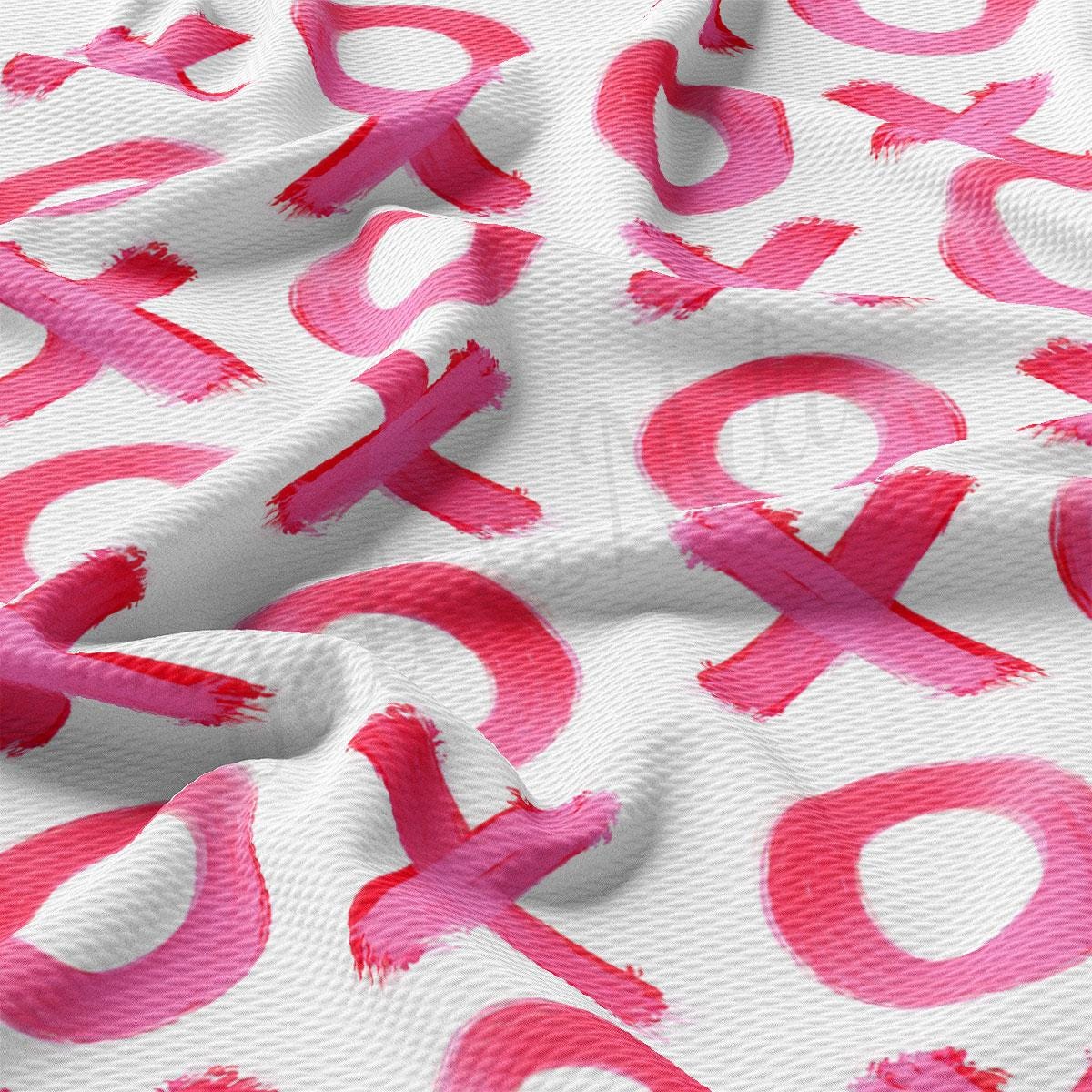 a white and pink fabric with pink letters on it