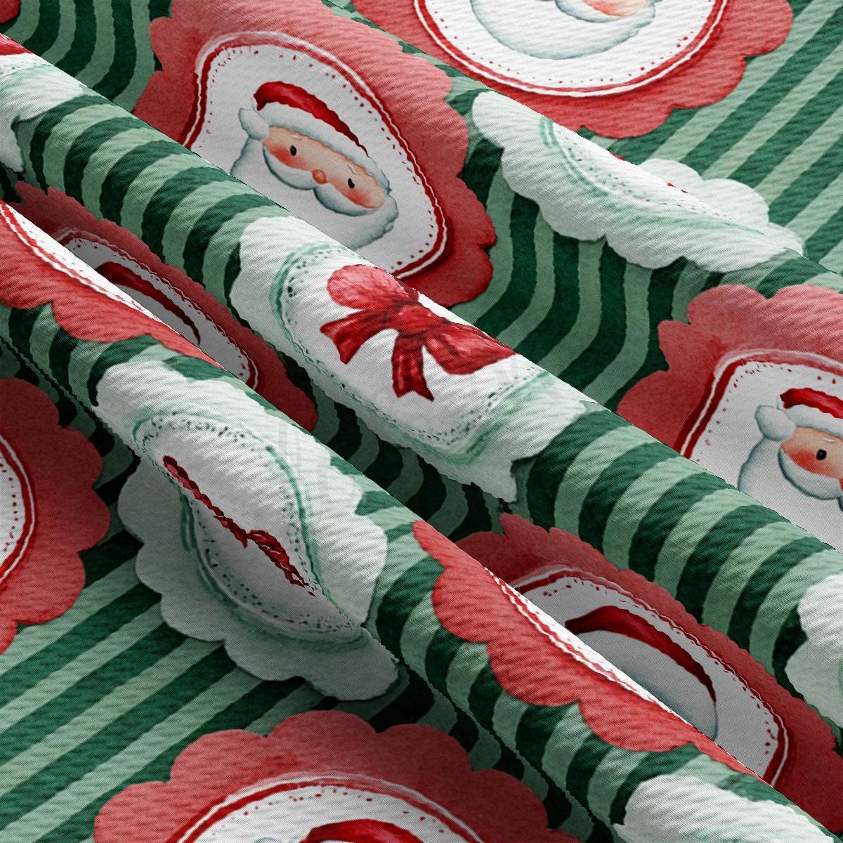 The image is a close-up of a fabric with a repeating pattern of Santa Claus and Christmas-themed elements, such as ribbons and flowers, against a green and red striped background.