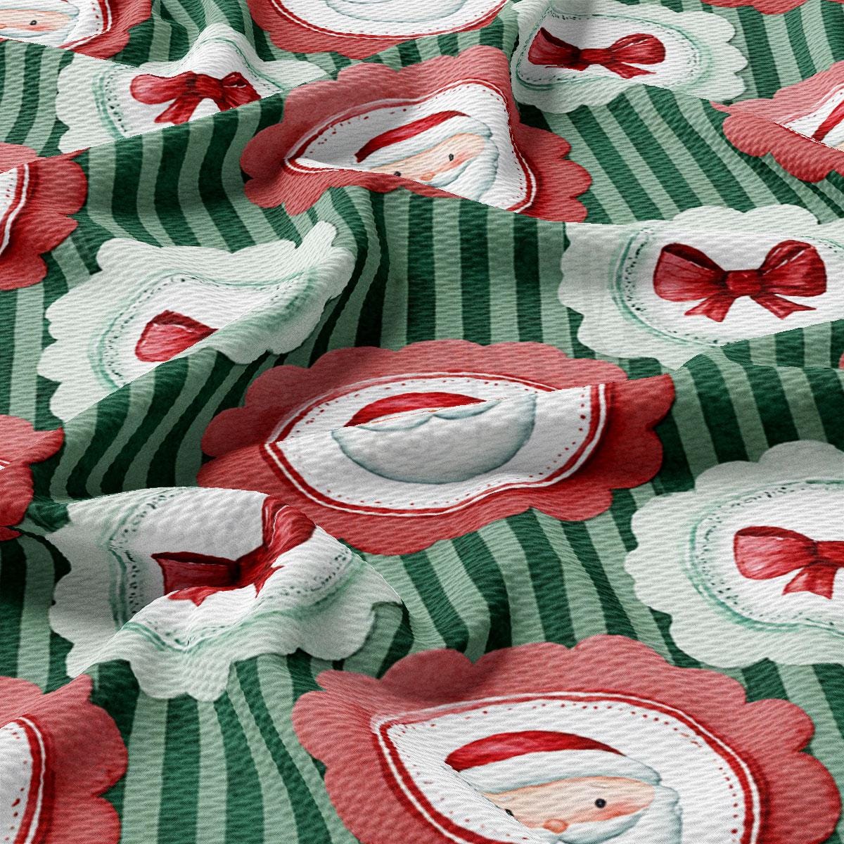 a close-up view of a fabric with a repeating pattern of Santa Claus and red bows on a green and white background.