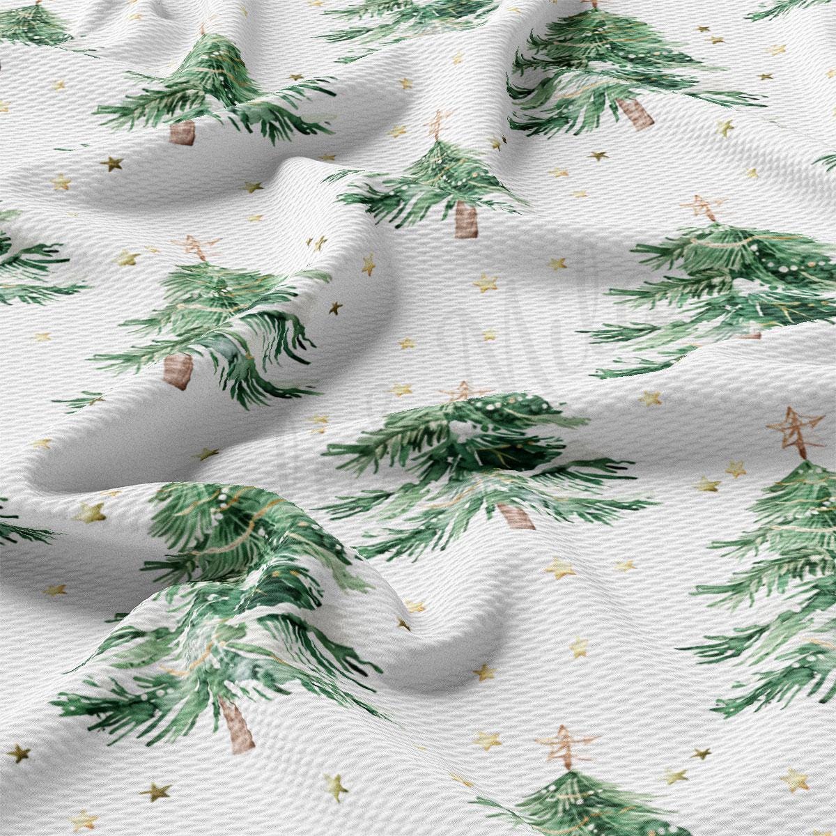 a close-up view of a fabric with a repeating pattern of green Christmas trees and gold stars. The pattern is intricate and detailed, with the trees and stars appearing to be hand-painted or printed onto the fabric.