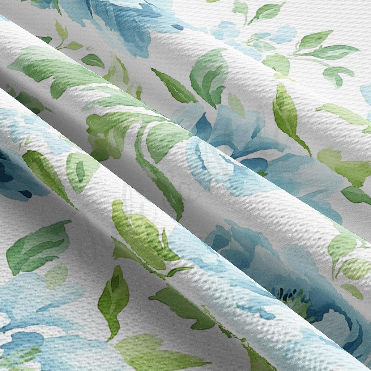 a close-up view of a fabric with a floral pattern in shades of green and blue. The fabric appears to be made of a soft, textured material, and the pattern is intricate and detailed.