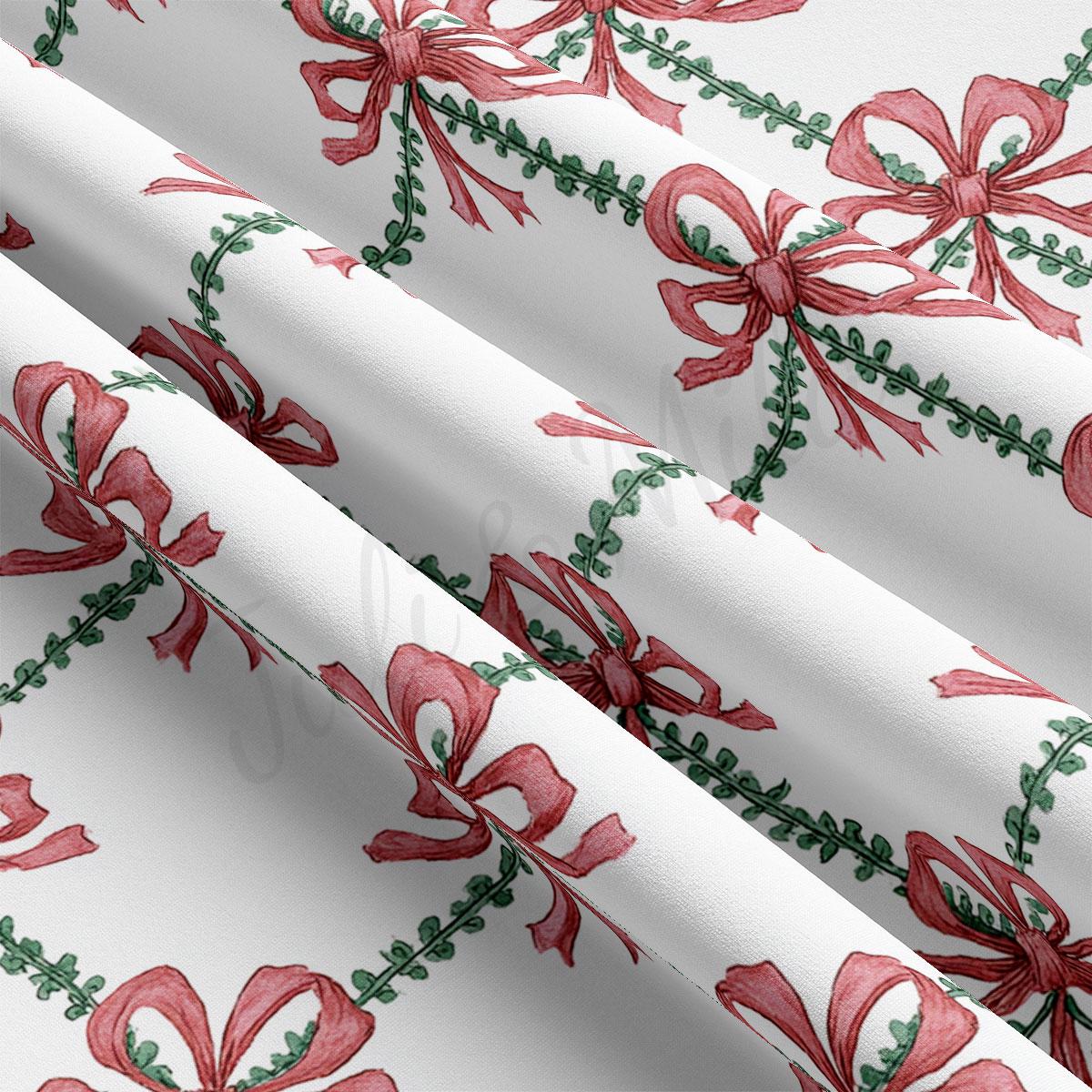 a close-up view of a fabric with a repeating pattern of red bows and green leaves. The bows are arranged in a diagonal pattern, creating a sense of movement across the fabric. The green leaves add a touch of color and texture to the overall design.